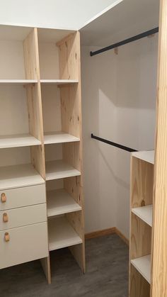 an empty walk in closet with shelves and drawers