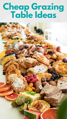 a long table filled with lots of different types of breads and pastries on it