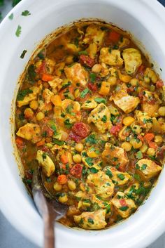 a white bowl filled with chicken and vegetable stew