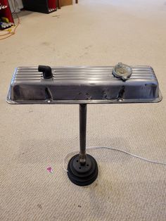 a metal table sitting on top of a carpeted floor