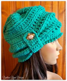 a mannequin head wearing a green knitted hat with buttons on the side