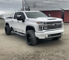 a white truck parked in front of a barn