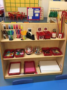 the shelves are filled with school supplies and stationery items for children to use in their classroom