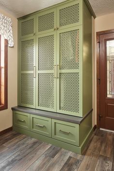 a large green cabinet with drawers in a room