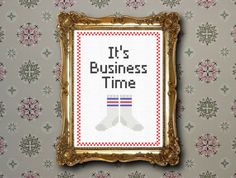 a cross stitch picture frame with the words it's business time