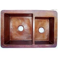 two square copper sinkes with one bowl in the middle and an oval hole at the top