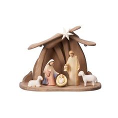 a nativity figurine with sheeps and a star on it's roof