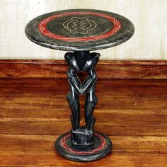 a small black table sitting on top of a wooden floor