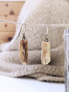 "A perfectly unique, handmade pair of driftwood earrings! The PETITE DRIFTWOOD DROP earrings are made from driftwood pieces approximately 1-1.5\" long and .25-.5\" thick.  Each piece of driftwood is unique and no two pieces or pairs are alike.  The pair in the photos is an example of the pair you will receive but not the exact pair. Your pair will be very similar in shape, size, color and texture.   We spend extra time scouring the beaches and riverbanks of the Middlewest searching for the perfect pieces!  Each piece of driftwood is lightly cleaned and sanitized and then coated with a matte clear coat to keep them in good condition for years to come.  All PETITE DRIFTWOOD DROP earrings come standard with brass ear wires and clear backs for extra security.  Do you have a metal sensitivity? Driftwood Jewelry Novica, Handmade Rustic Natural Earrings, Painted Driftwood, Driftwood Art Diy, Driftwood Jewelry, Driftwood Projects, Driftwood Crafts, Driftwood Art, Unique Materials