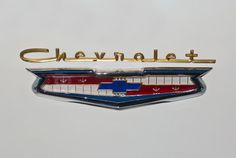 the chevrolet emblem is shown in red, white and blue with gold lettering on it