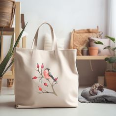 a white bag sitting on top of a table next to a potted plant