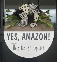 a wooden sign that says yes, amazon this house is again on the front door