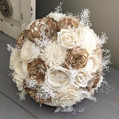 a bridal bouquet with white and brown flowers