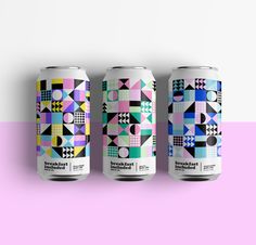 three cans of beer on a pink and white background with geometric shapes in pastel colors