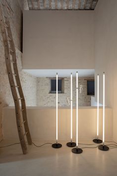 three lamps are standing in the middle of a room