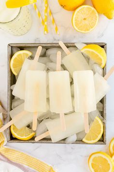 popsicles with lemons and ice on a tray