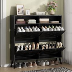 the shoe rack is holding many pairs of shoes and has two shelves on each side