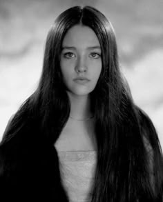 an old photo of a young woman with long hair