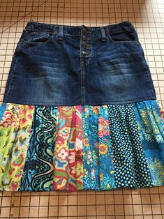 a skirt made out of old jeans with different patterns on the bottom and sides, sitting on a mat