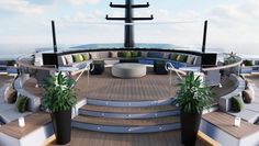 the interior of a large boat with seating and plants on it's deck, overlooking the ocean