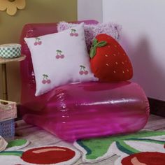 an inflatable chair with pillows and a strawberry on it