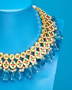 Drawing on jewelry from Mughal courts, the Sharawar Necklace in Sapphire Blue is an opulent showstopper. It adds a striking accent to many a NicoBlu style. May be worn as a reversible style, as the necklace is finished on both sides (one that is clear glass, the other repoussé enamel). • Gold plated • Sapphire blue glass • Reversible: clear glass on one side, repoussé enamel on the other • Slide tie closure, as shown • Hand-crafted • 6.5oz • Zinc free • Includes a NicoBlu gift bag (prints and co Temple Jewelry Necklaces With Jewels For Festivals, Festival Temple Jewelry Necklaces With Jewels, Elegant Blue Meenakari Necklace, Fusion Style Blue Necklace For Festive Occasions, Elegant Long Meenakari Necklaces, Elegant Long Meenakari Necklace, Fusion Style Blue Kundan Jewelry, Elegant Turquoise Kundan Necklace For Festive Occasions, Blue Kundan Necklace For Celebration