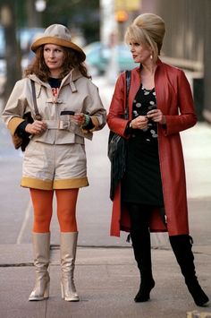 two women walking down the street talking to each other