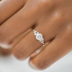 a woman's hand with a diamond ring on it