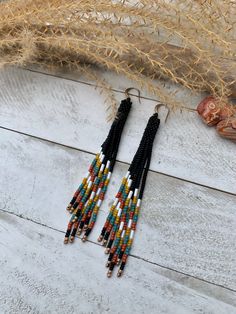 Long Beaded Tassel Earrings Beaded Earrings Southwestern Seed Bead Earrings Triangular Style Earrings Western Style Turquoise White Earrings These fun earrings are a great addition of color to any outfit! Very lightweight and eye catching!  Handmade with glass seed beads and paired with an antique gold earwire.  Length is approximately 4 inches in length. All designs, photos, and descriptions are property of TwistedRiverDesign! All designs, photos, and descriptions are property of TwistedRiverDesign! Tassel Beaded Earrings, Southwestern Multicolor Fringe Earrings, Southwestern Beaded Earrings With Tassels For Festival, Southwestern Fringe Earrings With Round Beads, Southwestern Tassel Earrings For Festivals, Adjustable Southwestern Beaded Earrings For Beach, Southwestern Style Beach Jewelry With Dangling Beads, Southwestern Fringe Dangle Earrings, Southwestern Beaded Fringe Dangle Earrings