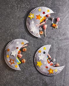 two paper plates with stars and candy on them, one is shaped like the moon