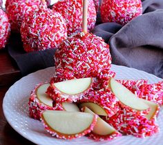 apples are covered in sprinkles on a plate