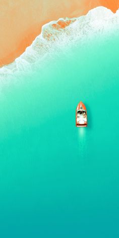 a small boat floating on top of a body of water next to an orange beach