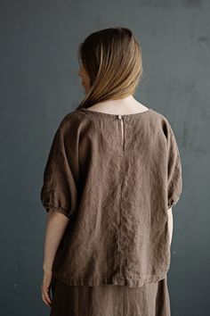 Tunic is made from 100% soft and washed linen. Match it with our skirts! Details: - Composition: 100% Oeko-Tex certified linen - Colour: cacao - Button in the back - Dropped shoulders - Size: One size/fits all - Medium weight linen - Linen care: machine wash gentle; tumble dry low, ironing optional - The price is for one tunic, other pictured items are not included Measurements: Length from neck down: 55 cm (21,66 in) Chest width: 140 cm (55,1 in) Sleeve length (from collar): 37 cm (14,6 in) Bot Brown Relaxed Fit Top For Daywear, Brown Linen Relaxed Fit Tops, Brown Linen Spring Tops, Relaxed Fit Ramie Blouse For Daywear, Brown Linen Tops For Spring, Brown Relaxed Fit Linen Top, Casual Ramie Tops For Daywear, Oversized Bohemian Linen Tops, Relaxed Fit Ramie Tops For Daywear