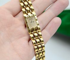 Brand: Piaget Mavement: Quartz Case Material: 18K Yellow Gold Case size: 14*24 mm Thickness: 5 mm Dial: Full of diamonds; Gold color hands Bracelet: 18K Yellow gold with custom Diamond on a clasp wrist size: Approximately 5-5.5 inch. Possible to add custom links Weight of the watch: 44.3 GM Additional services such as refinishing and appraisal will be at extra cost ! We guarantee that all of our items are 100% authentic ! For additional photos and any inquiries, please send us a Direct Message ! Rectangular Yellow Gold Diamond Watch, Yellow Gold Diamond Watch Gift, Designer Yellow Gold Diamond Watch, Designer Yellow Gold Diamond Watch Gift, Designer Yellow Gold Diamond Watch As Gift, Gold Diamond Hallmarked Watch Gift, Designer Gold Diamond Watch As Gift, Designer Gold Diamond Watch With Polished Finish, Luxury Gold Diamond Watch Hallmarked