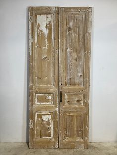 an old wooden double door with peeling paint