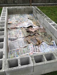 a pile of newspapers sitting on top of cement blocks