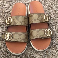 Brand New Worn Once Coach Sandals With Buckle Closure And Round Toe, Luxury Coach Sandals With Round Toe, Designer Coach Sandals, Coach Sandals With Leather Footbed, Coach Sandals With Leather Footbed And Round Toe, Coach Leather Slides With Round Toe, Casual Coach Sandals With Leather Footbed, Coach Leather Slides For Spring, Chic Brown Slides With Round Toe