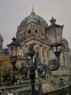 a large building with a dome on top next to a body of water