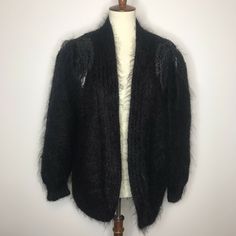 Colleen Toland Vintage Cardigan Hand Knitted Eyelash Sweater (Angora?) Black Leather and Beaded Embellished Size Large Please use photos and zoom as part of the description. Flat Lay measurements Sleeve - from edge of shoulder pad to hem - 24" Chest - 23" Length down center back - 29" Thanks for viewing! Cozy Hand Knitted Black Cardigan, Vintage Black Sweater With Buttons, Black Embellished Winter Cardigan, Vintage Black Cardigan With Button Closure, Black Textured Knit V-neck Cardigan, Vintage Cardigan, Hand Knitted Sweaters, Shoulder Pads, Black Sweaters