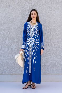 "**Note : The kaftan in the video is a different color of the exact same Kaftan and is only displayed to show the fit, flow, and cut of the Kaftan. You will receive the one in the pictures.** This beautiful Kaftan with the Siwa inspired embroidery is a bohemian and flashy dress that will catch everyone's eyes. it is a show stopper. This Kaftan is ideal to wear for any casual occasion. Whether taking a trip down the shopping lane, or home-based kitty parties, or about anything else, wearing this Blue Dabka Maxi Length Abaya, Embroidered Blue Long Sleeve Abaya, Blue Maxi Kaftan With Dabka Detail, Blue Maxi Length Kaftan With Dabka, Traditional Blue Maxi Dress For Eid, Blue Dabka Kaftan Maxi Length, Long Sleeve Blue Abaya With Floral Embroidery, Bohemian Blue Thobe For Vacation, Blue Bohemian Dress With Dabka