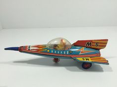 a toy airplane with a glass ball on it's wing and the number 5