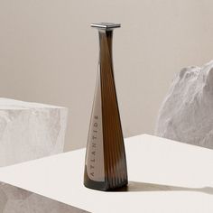 a brown vase sitting on top of a white table