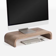 a computer monitor sitting on top of a wooden stand