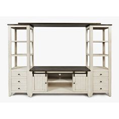 a white entertainment center with shelves and drawers