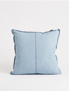 a blue pillow sitting on top of a white table