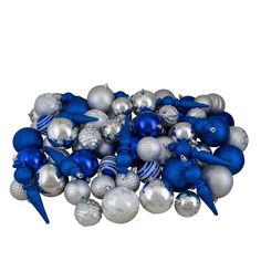 a pile of blue and silver ornaments sitting on top of a white floor next to each other