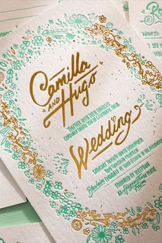 wedding stationery with gold foil lettering on green and white paper, surrounded by flowers