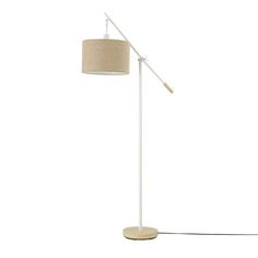 a white floor lamp with a beige shade