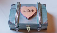 a wooden box with a heart and initials on it