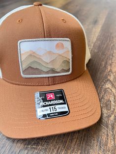 This unique mountain scene print stitch patch hat will be the perfect on trend gift for the outdoorsman in your life! Richardson 115 Snapback Trucker Style Hat.  Trendy hat for men Outdoor gift for men Christmas gift for husband Christmas gift for son Hat for son Hat for men Print Stitch patch hat Outdoor Snapback Hat With Embroidered Patch, Brown Trucker Hat With Patches, Brown Outdoor Hat With Embroidered Patch, Outdoor 5-panel Hat With Logo Patch, 5-panel Trucker Hat With Patches, Christmas Presents For Dad, Stitch Patch, Laser Design, Christmas Gifts For Husband